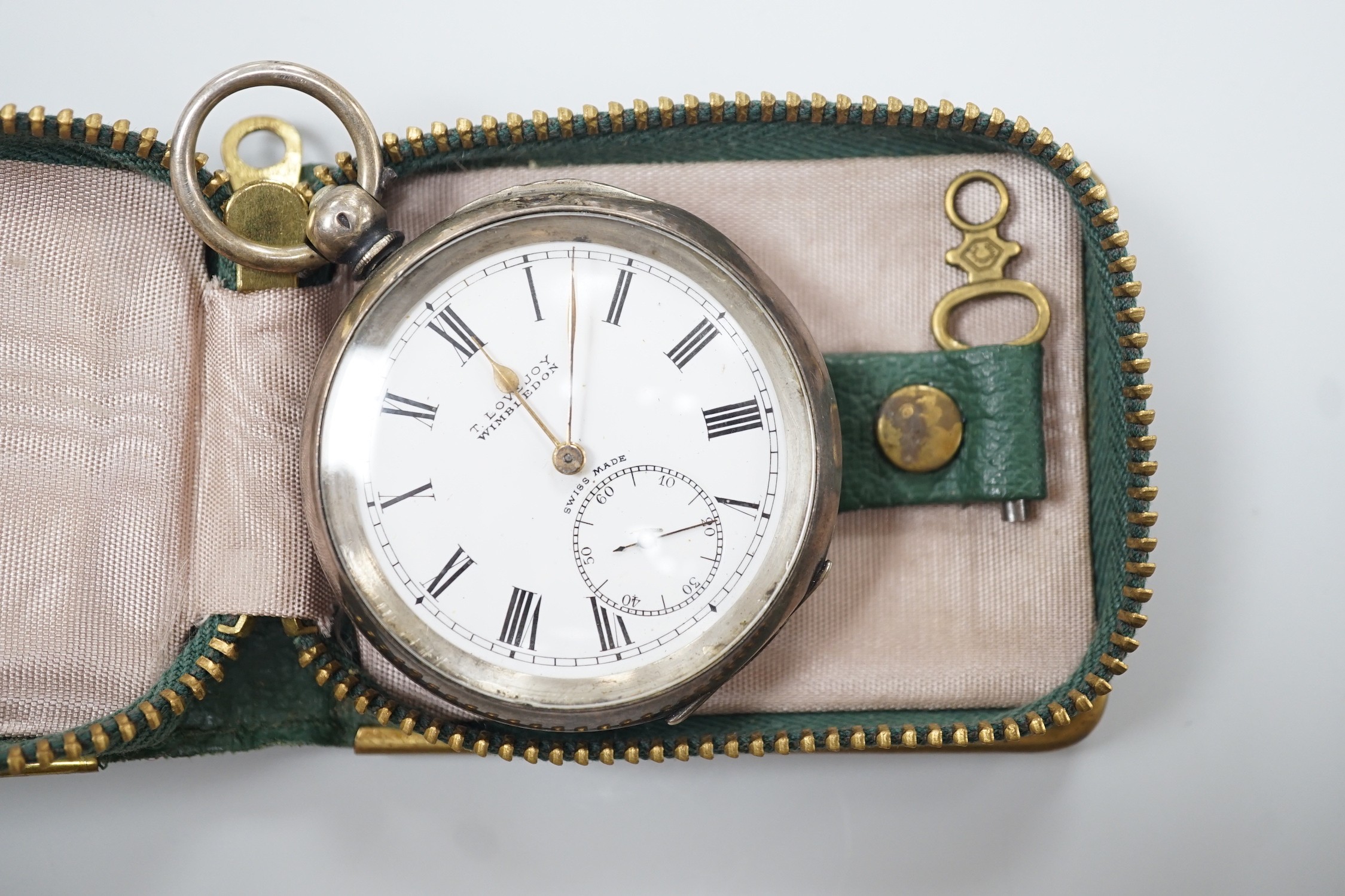 A Swiss open faced keywind pocket watch, retailed by Lovejoy, Wimbledon, with Roman dial and key.